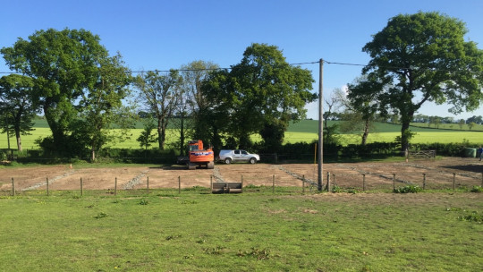 Base construction of the horse arena with the drains in place