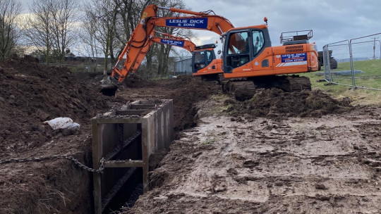 Safety shuttering for when working in deep trenches. This is dragged along the trench by a chain