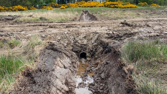 Ditching and a section of twin-wall pipe under access track