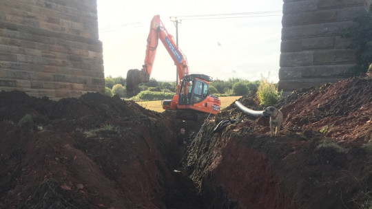 Digging the deep drain under the railway viaduct